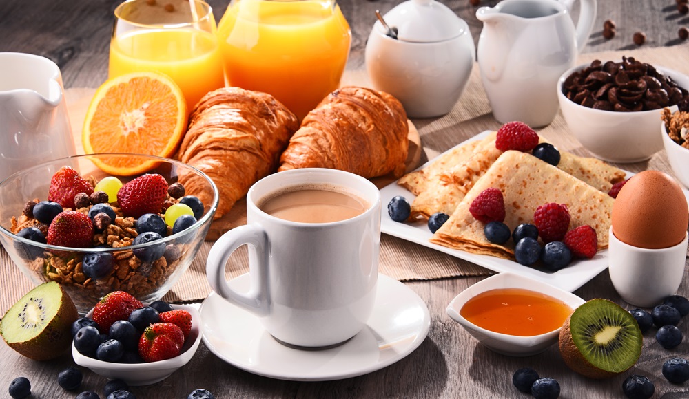 Breakfast served with coffee, juice, croissants and fruits