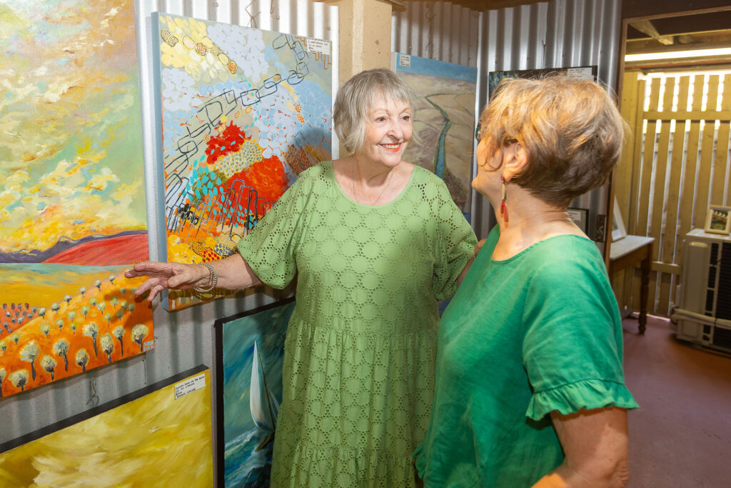 Photo of two ladies discussing art