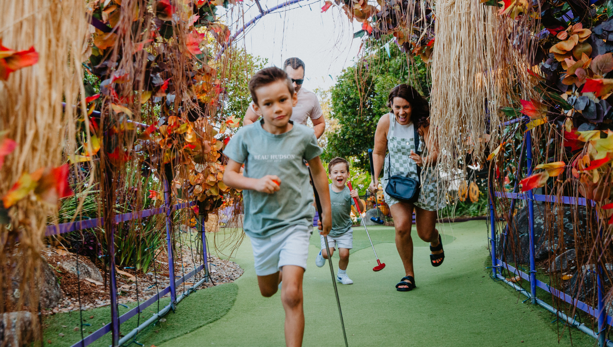 Family having fun at the Spooky Putt Putt course