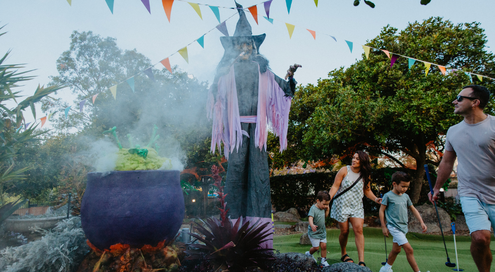 Family having fun at the Spooky Putt Putt course